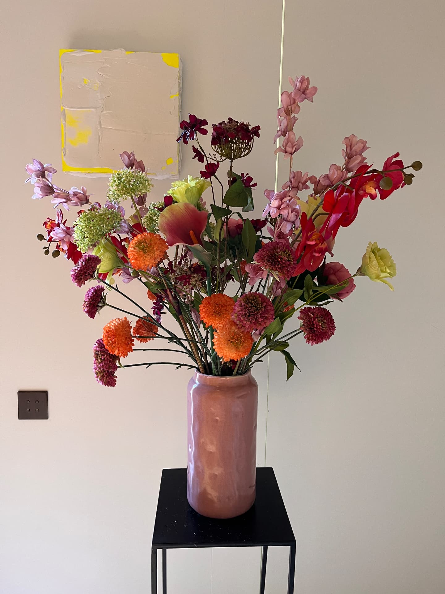 Kleurrijk zijden boeket in een roze vaas