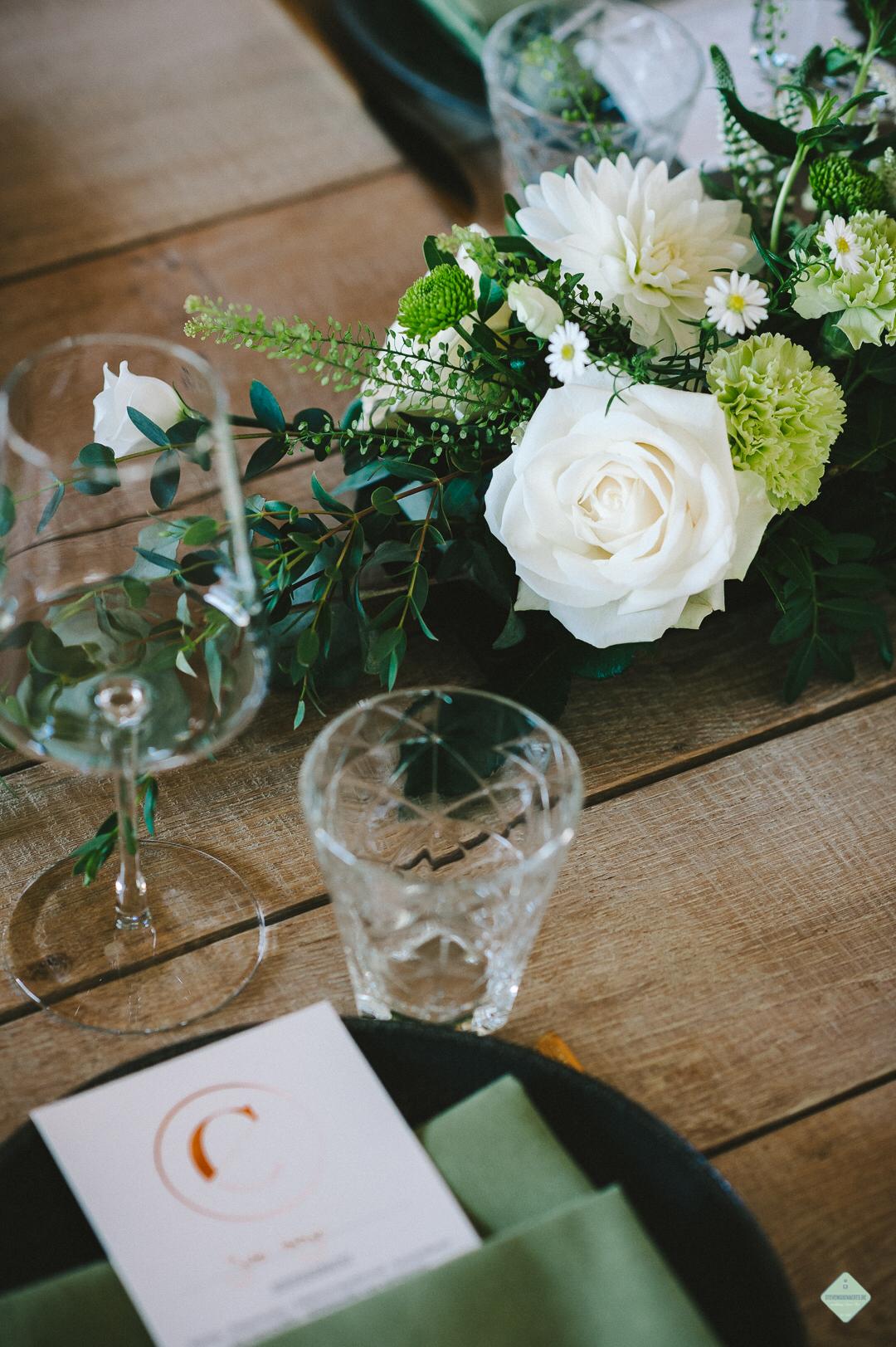Elegant corporate dinner table with pastel floral centerpieces